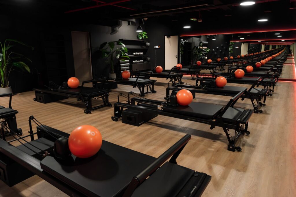 Reformer Pilates studio with orange balls at Pure Motion Dubai
